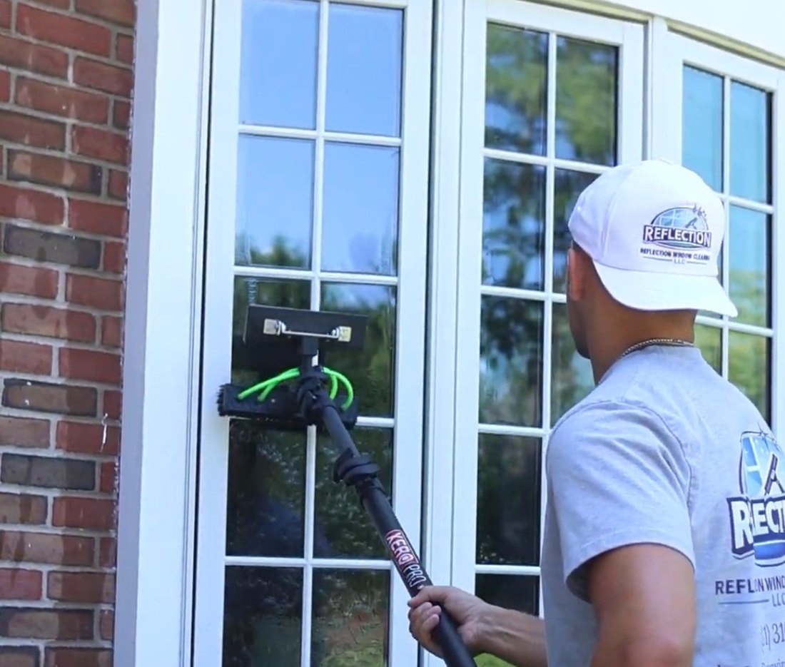 Reflection technician cleaning interior windows